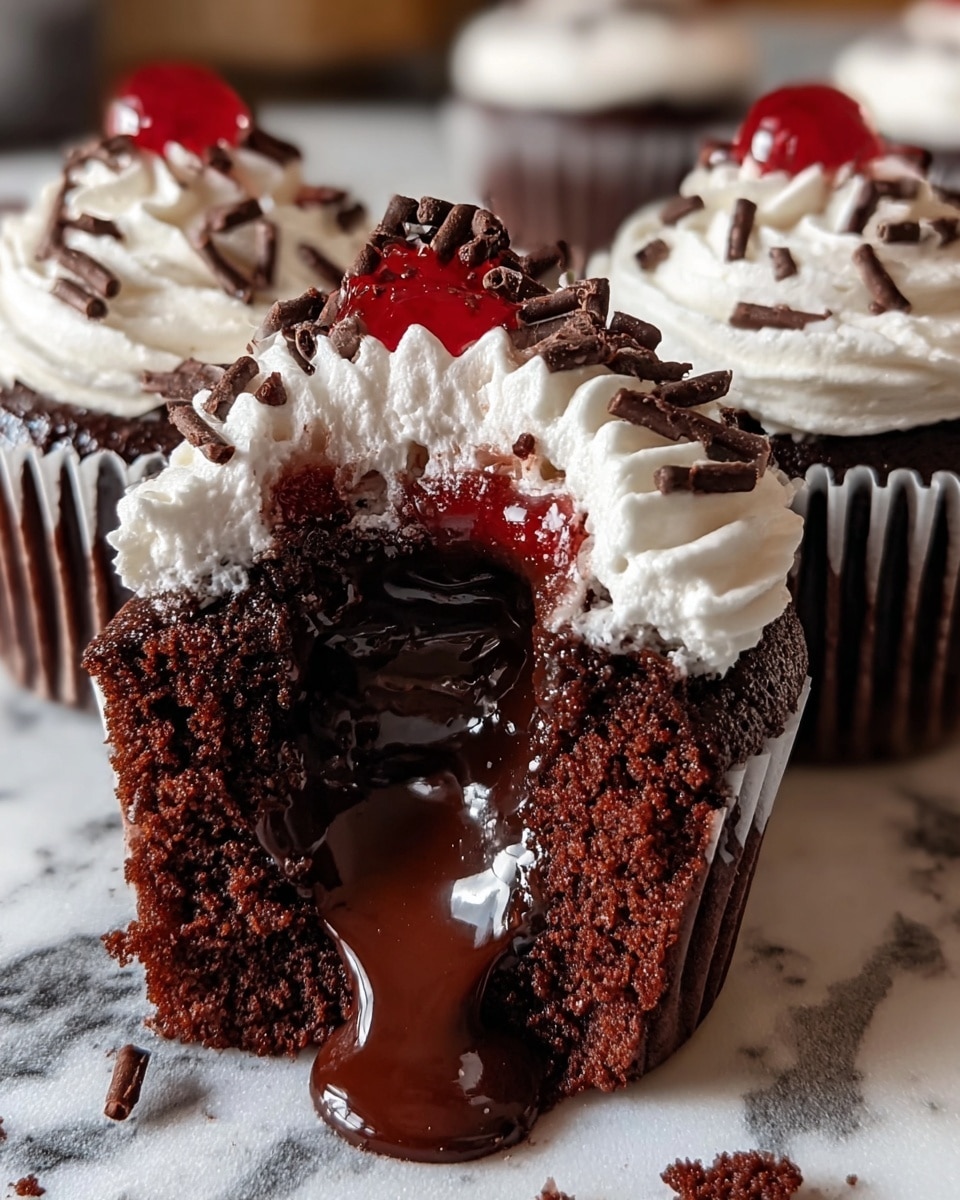 A rich chocolate cupcake is cut open in the center, revealing a thick, shiny dark chocolate filling that gently spills out onto the white cupcake liner below. The cupcake itself is dark brown and moist, topped with a smooth swirl of white whipped cream frosting that is decorated with small pieces of chocolate shavings and a few drops of red syrup. Surrounding the cut cupcake are two other whole chocolate cupcakes, each topped with the same white whipped cream and chocolate shavings. All cupcakes are placed on a black wire rack set on a white marbled surface. Photo taken with an iphone --ar 4:5 --v 7