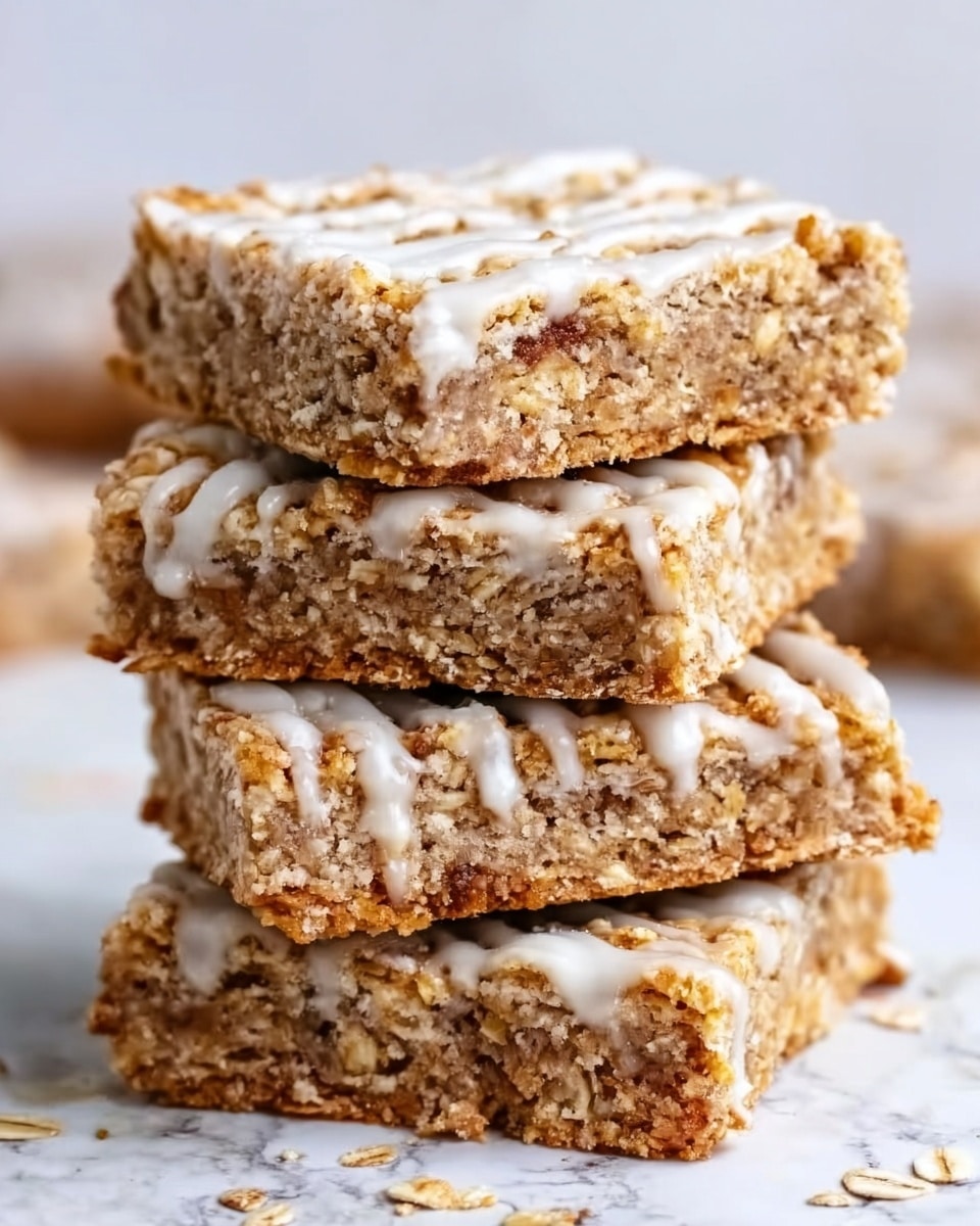 The image shows a stack of three oat bars on a white marbled surface. Each bar has two main layers: a thick, crumbly golden brown oat base with visible oats and a smooth white icing layer on top, slightly dripping down the sides. The bars have a rough, crunchy texture with oats sticking out, and the icing looks creamy and sweet, creating a nice contrast in colors and textures. Photo taken with an iphone --ar 4:5 --v 7