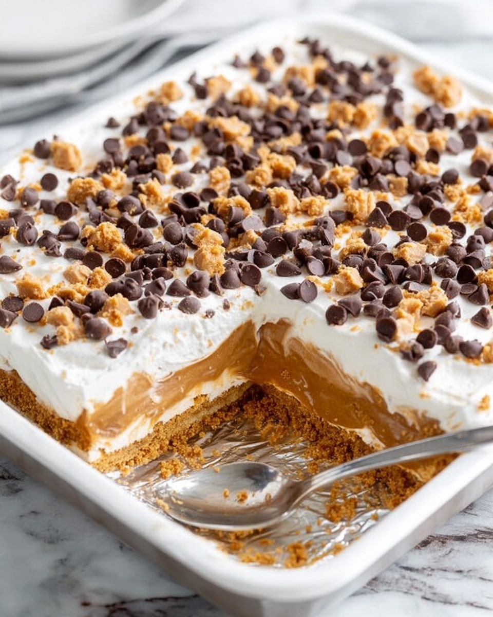 The dish is a square-shaped layered dessert shown first in a white-lined baking pan with one piece removed and a spoon resting inside. It has three clear layers: a bottom layer of light brown, crumbly crust; a middle layer of bright orange pumpkin filling; and a thick top layer of creamy white whipped topping. The top is covered evenly with small dark brown chocolate chips and light tan crunchy bits. The second image shows a single slice of the dessert on a white plate with one bite taken by a fork, revealing the soft, creamy texture of the pumpkin layer blending with the whipped topping, topped with scattered chips and crunchy pieces. The background surface is a white marbled texture. photo taken with an iphone --ar 4:5 --v 7